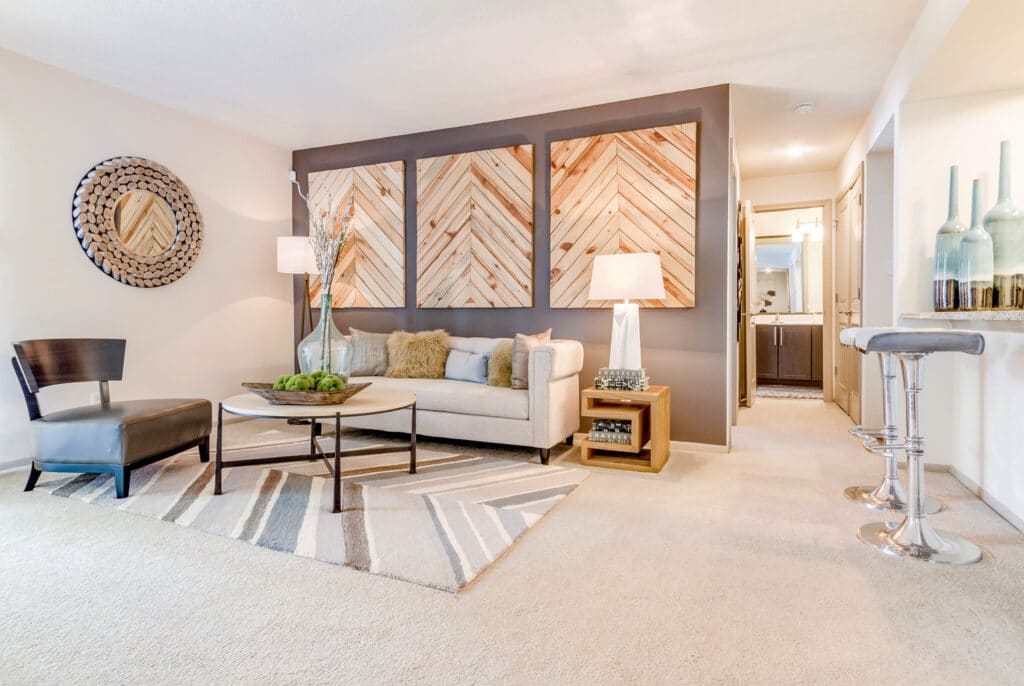 Madison South Park Apartments | carpeted living room and breakfast bar